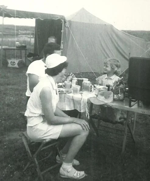 A family eating while camping in the 1950s.
